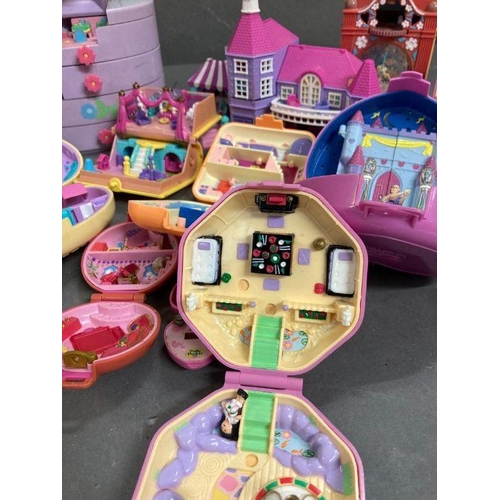 708 - An extensive selection of Polly Pocket toys  to include clocks and make up case