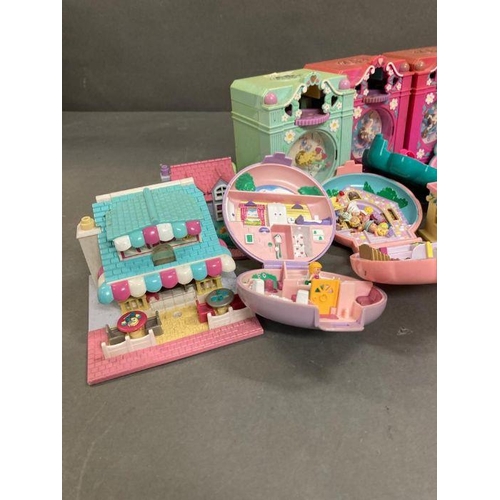 708 - An extensive selection of Polly Pocket toys  to include clocks and make up case