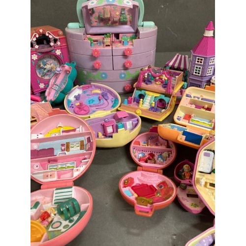 708 - An extensive selection of Polly Pocket toys  to include clocks and make up case