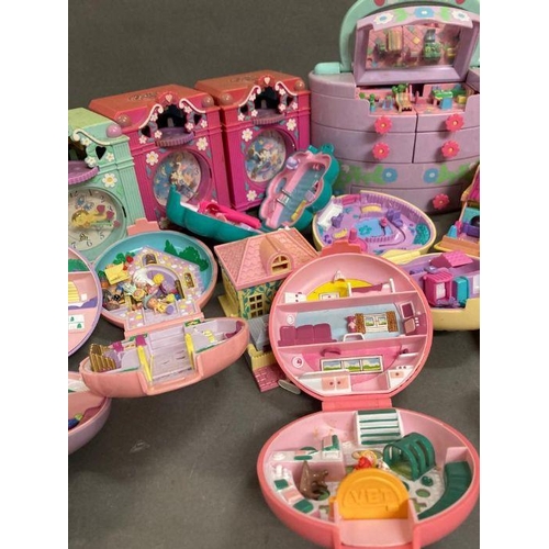 708 - An extensive selection of Polly Pocket toys  to include clocks and make up case