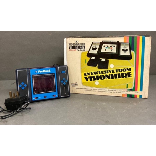 711 - A Video master Vision score console and a Pacman two, two player video game