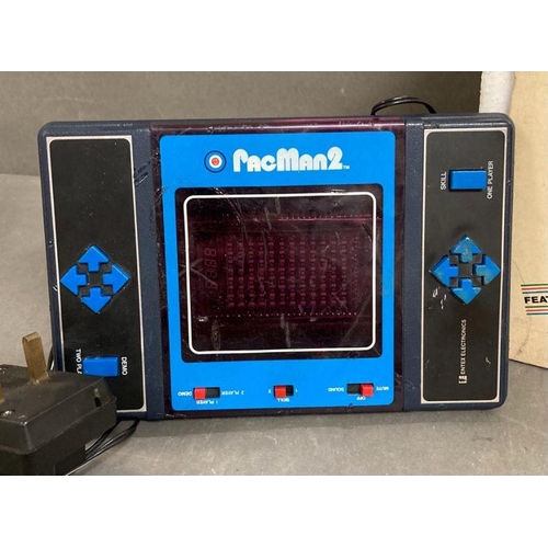 711 - A Video master Vision score console and a Pacman two, two player video game