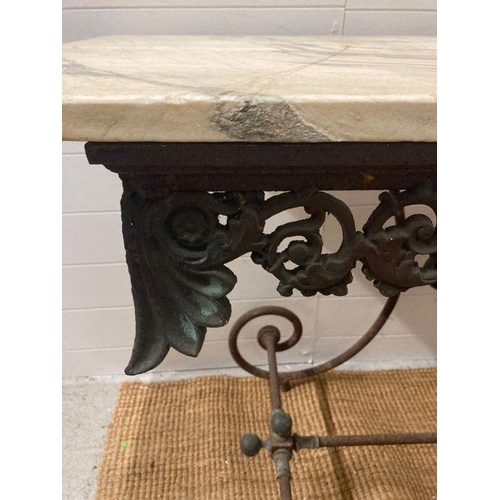 79 - A French marble top garden table on an ornate cast iron base