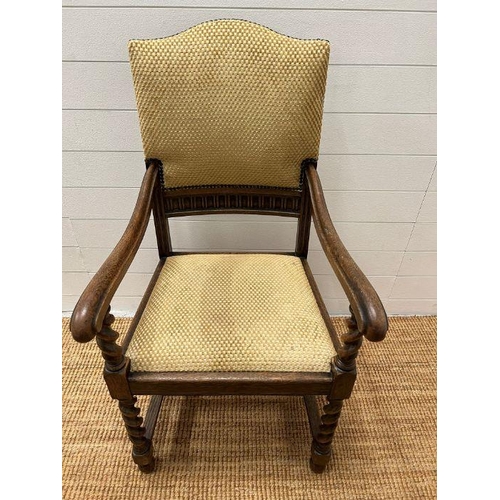 89 - An oak elbow chair with barley twist front supports and upholstered seat pads