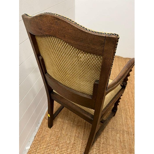 89 - An oak elbow chair with barley twist front supports and upholstered seat pads