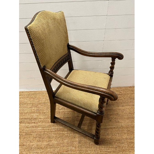 89 - An oak elbow chair with barley twist front supports and upholstered seat pads