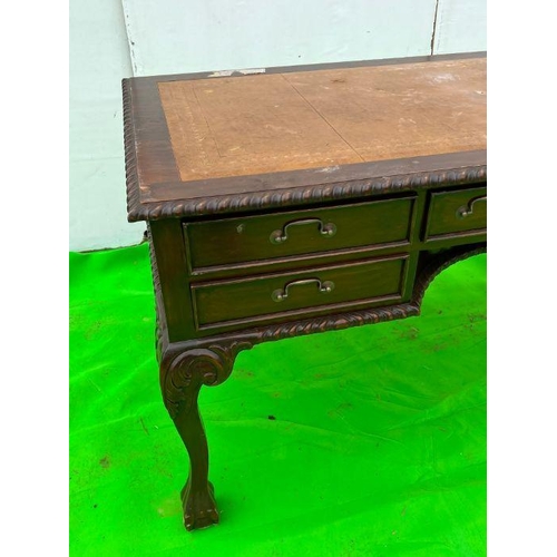 94 - A mahogany desk on ball and claw feet (H80cm W160cm D80cm)