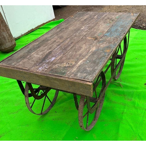 96 - A vintage reclaimed cart, wooden planked top on metal frame and spindle wheels (H58cm Q127cm D69cm)