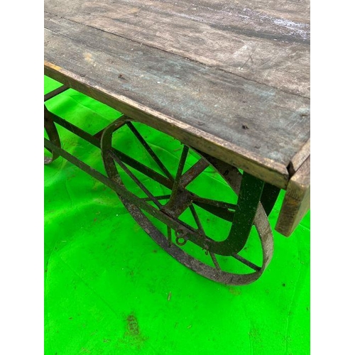 96 - A vintage reclaimed cart, wooden planked top on metal frame and spindle wheels (H58cm Q127cm D69cm)