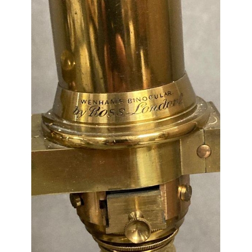 723 - A 19th Century Wenham binocular petrological microscope by Ross of London, cased on plinth in a glas... 