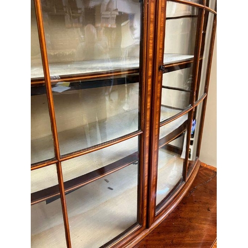 1 - A bow fronted secretaire style bookcase with three graduating drawers (H190cm W103cm D49cm)