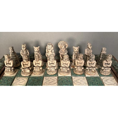 103 - A large Aztec and Spanish wooden resin chess set