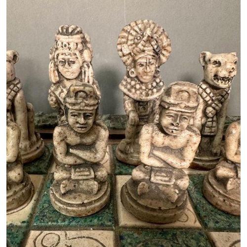 103 - A large Aztec and Spanish wooden resin chess set