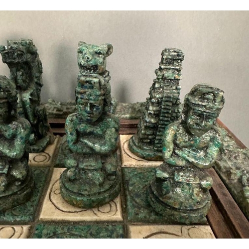 103 - A large Aztec and Spanish wooden resin chess set