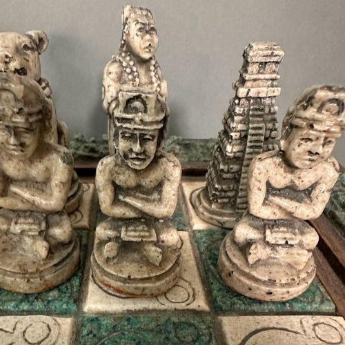 103 - A large Aztec and Spanish wooden resin chess set