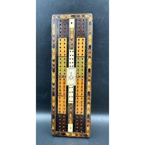 104 - A very interesting Victorian cribbage board made of Various woods with the Masonic set Square and co... 