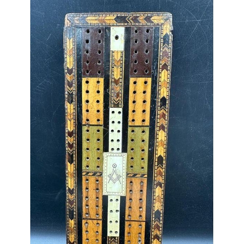 104 - A very interesting Victorian cribbage board made of Various woods with the Masonic set Square and co... 