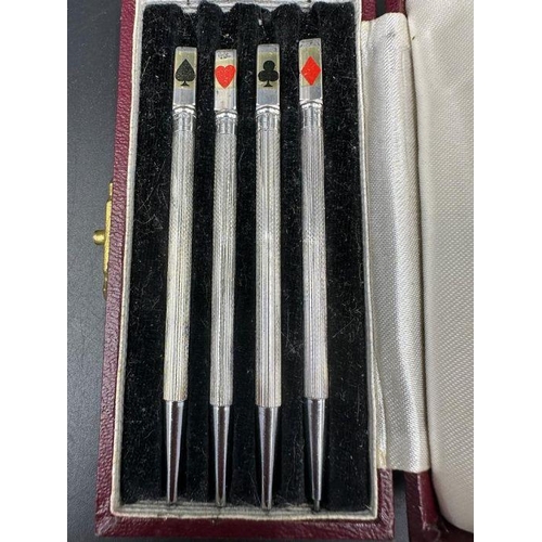 116 - A cased set of 4 Art Deco silver and enamel bridge pencil markers, c.1930, engine turned in fitted M... 