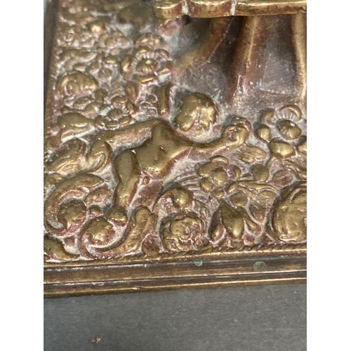 121 - A Victorian style brass candle holder with cherubs to base and stem