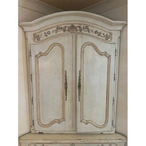 21 - A large French style corner unit with panelled doubled doors to top and bottom opening to reveal she... 