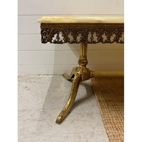 31 - An onyx topped brass frame coffee table on down swept legs with empire column stretcher and a nest o... 