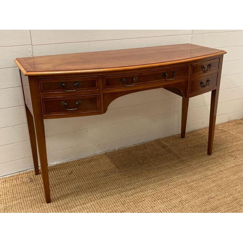 32 - A yew sideboard, bow fronted four drawer configuration (H79cm W130cm D51cm)