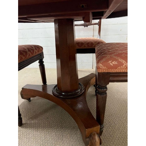 33 - A William IV style mahogany dining table, circular top over a octagonal column and raised on a tri-f... 