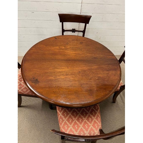 33 - A William IV style mahogany dining table, circular top over a octagonal column and raised on a tri-f... 