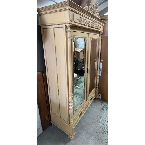 38 - A French style double wardrobe or armoire, the double doors flanked by fluted columns and opening to... 