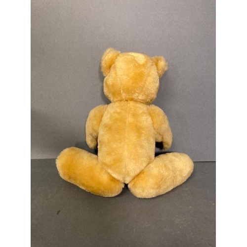 40 - A vintage teddy bear with jointed arms and legs.