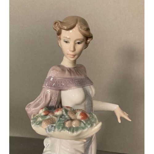 72 - A Lladro lady with a basket of fruit