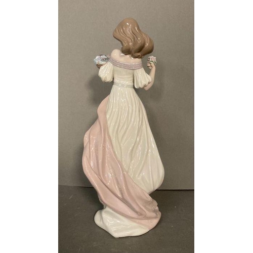 77 - A Lladro lady with a basket of fruit and a posey