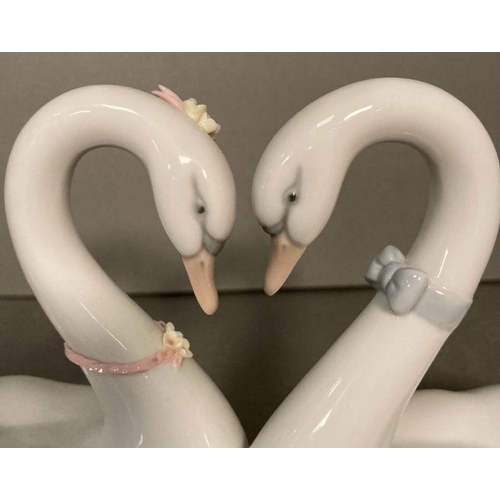 79 - A pair of Lladro necking swans