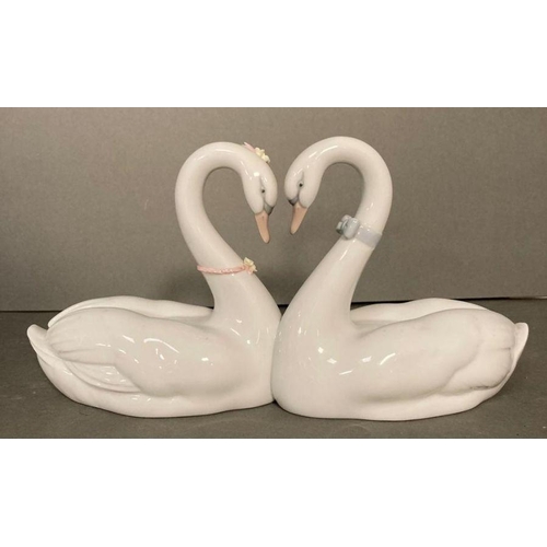 79 - A pair of Lladro necking swans