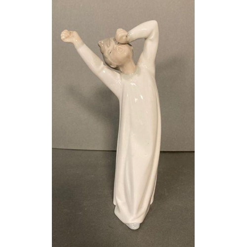 81 - Two Lladro figures- A young boy yawning and a young girl doing homework