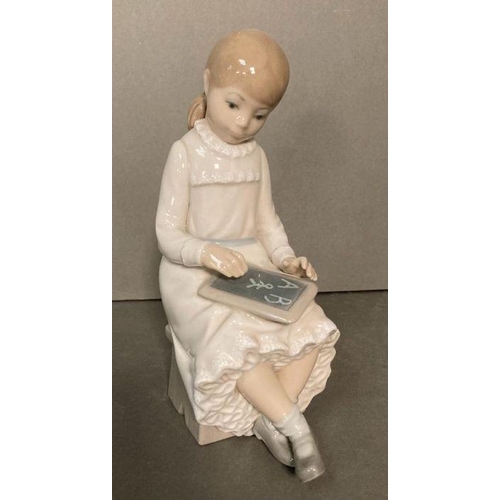 81 - Two Lladro figures- A young boy yawning and a young girl doing homework