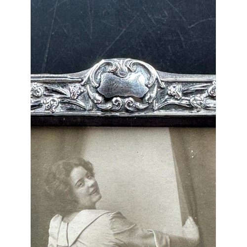 84 - A good Art Nouveau silver embossed photograph frame, Birmingham 1901, together with period 1915 sepi... 