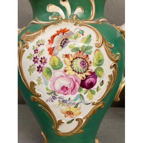 85 - A pair of 19th Century green grounds floral decorated two handled vases, hand painted H23cm