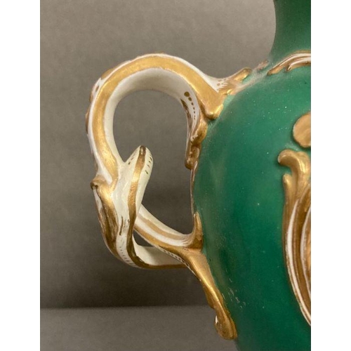 85 - A pair of 19th Century green grounds floral decorated two handled vases, hand painted H23cm