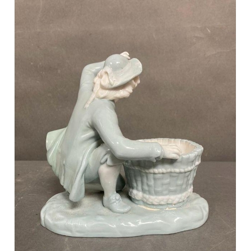 98 - A late Victorian Mintons porcelain figure of a boy with a basket, marked to base