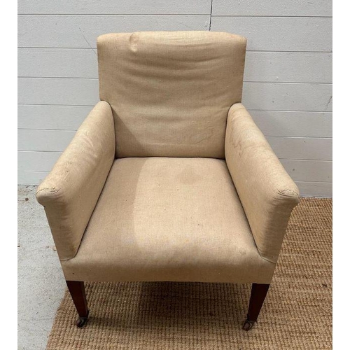 12 - An armchair on castors in need of re-upholstery