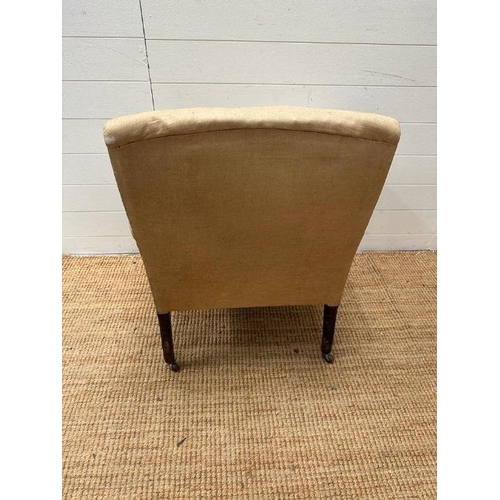 12 - An armchair on castors in need of re-upholstery