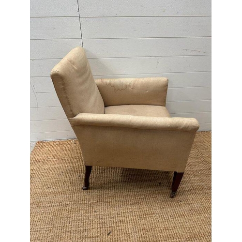 12 - An armchair on castors in need of re-upholstery