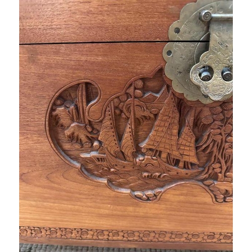 14 - A Camphor chest with Oriental carving depicting boats in a harbour scene with floral boarder ( H 59c... 