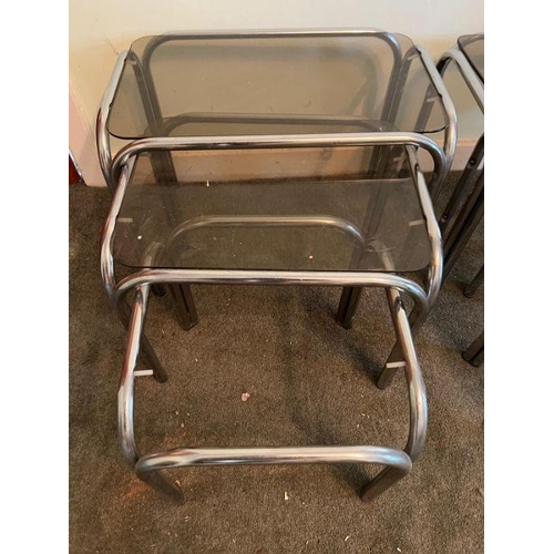 20 - Two sets of vintage nesting side tables, smoked glass and chrome tubular frame (One missing glass) (... 