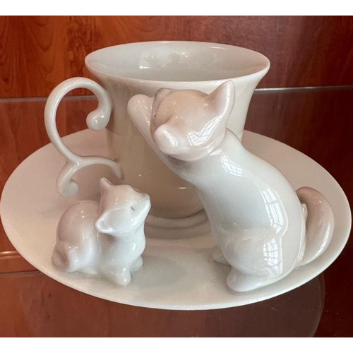 255 - A Lladro cup and saucer with cats playing to side