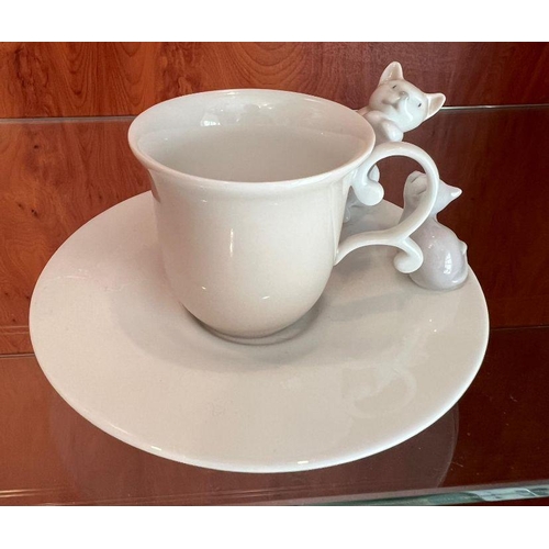 255 - A Lladro cup and saucer with cats playing to side