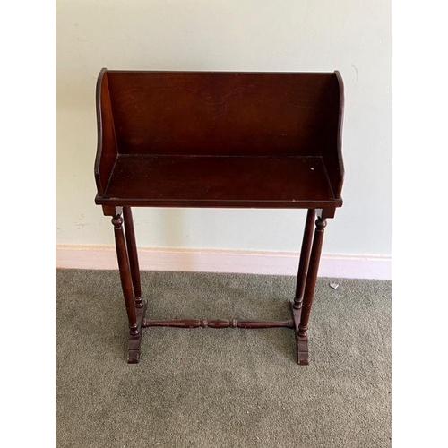 27 - A mahogany book stand on turned legs (H70cm W48cm D19cm)