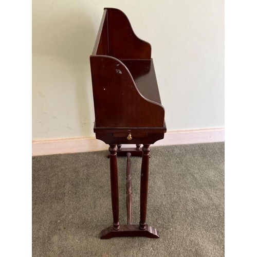 27 - A mahogany book stand on turned legs (H70cm W48cm D19cm)