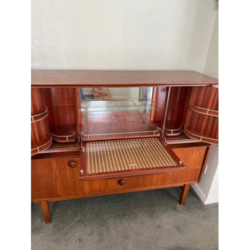 32 - A teak drinks cabinet by Bea utility (H107cm W130cm D45cm)
